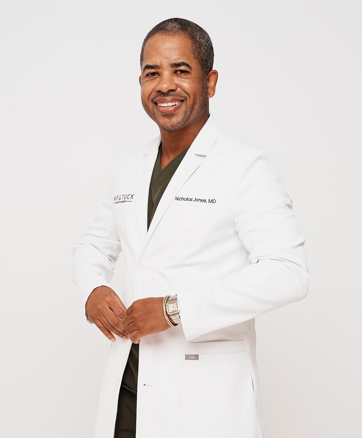 Doctor in white coat smiling confidently.