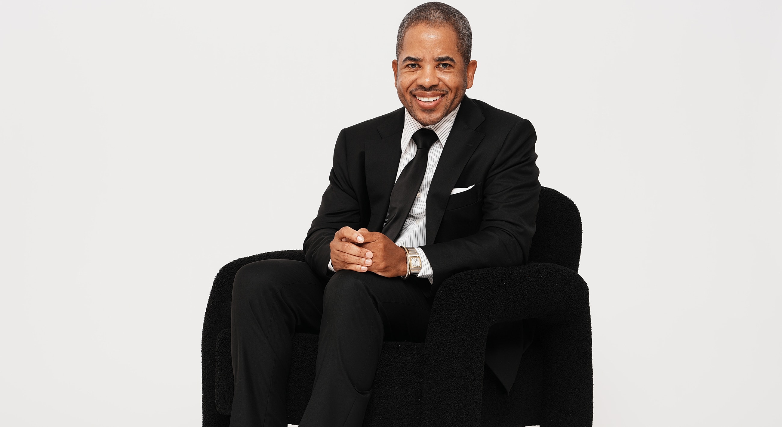 Group of people in elegant black outfits celebrating.