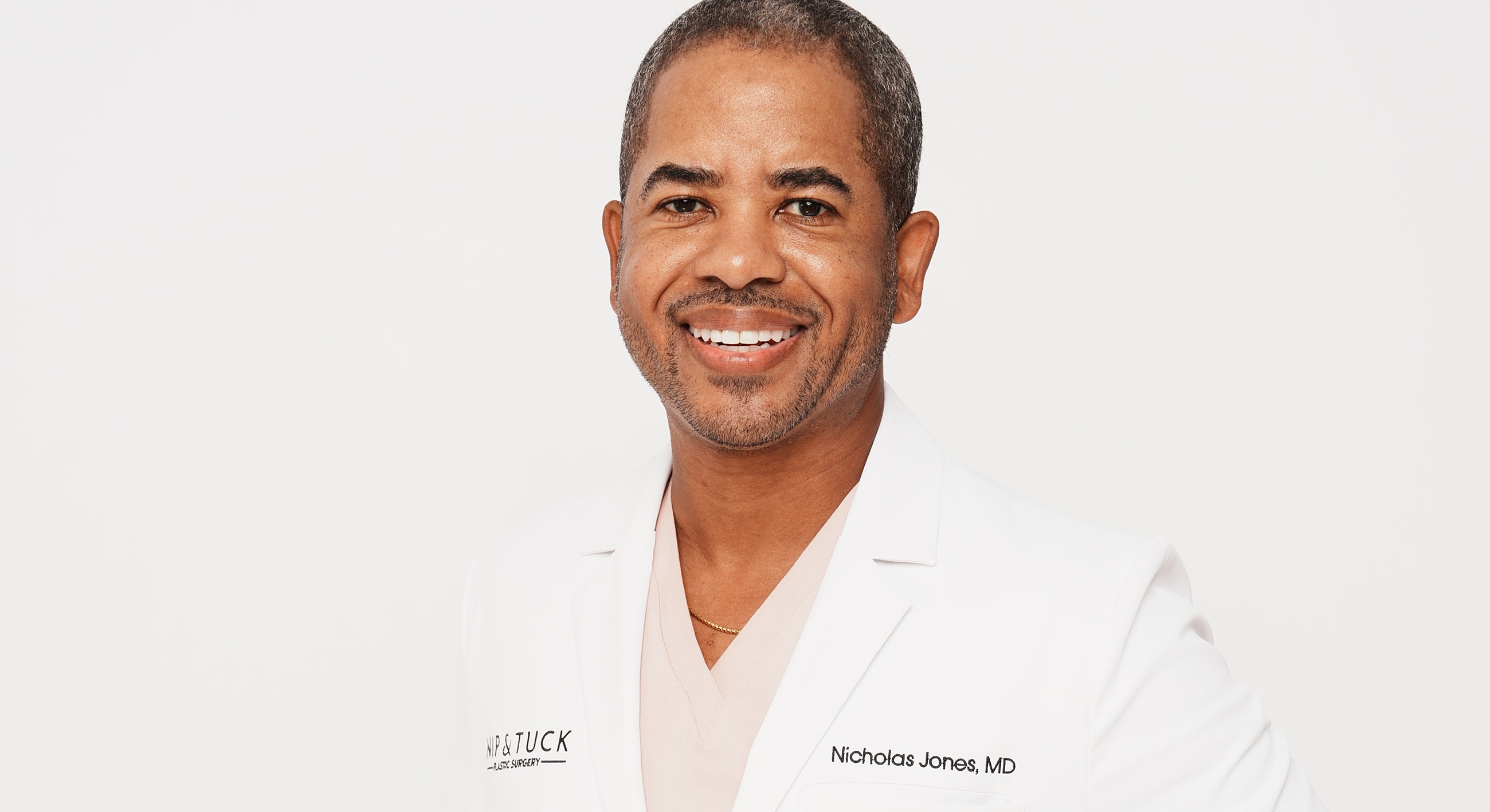 Smiling doctor in a white lab coat.